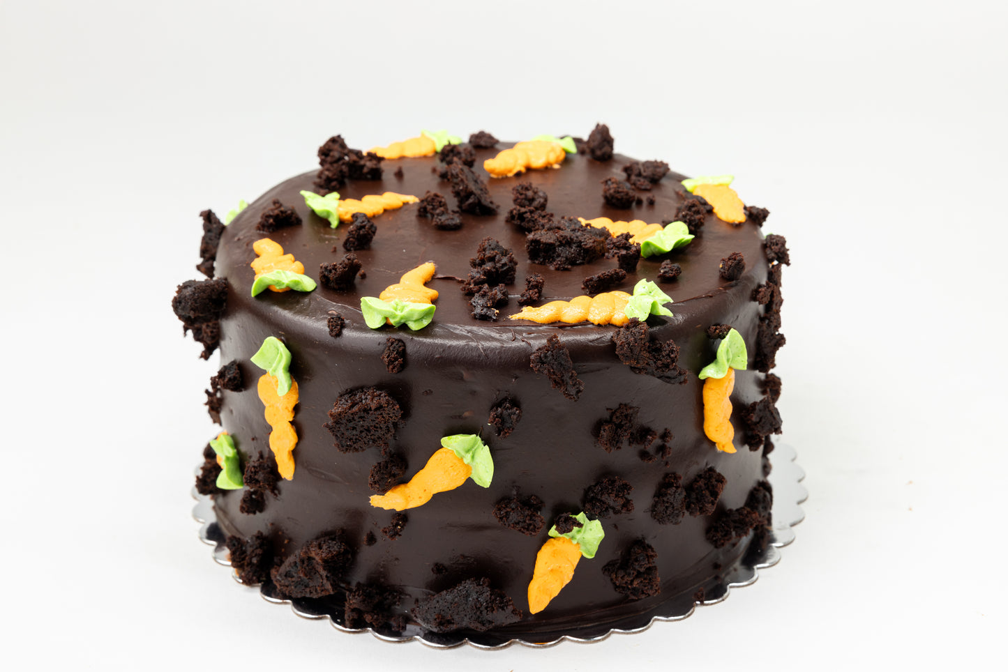 Chocolate cake with buttercream carrots on a white background