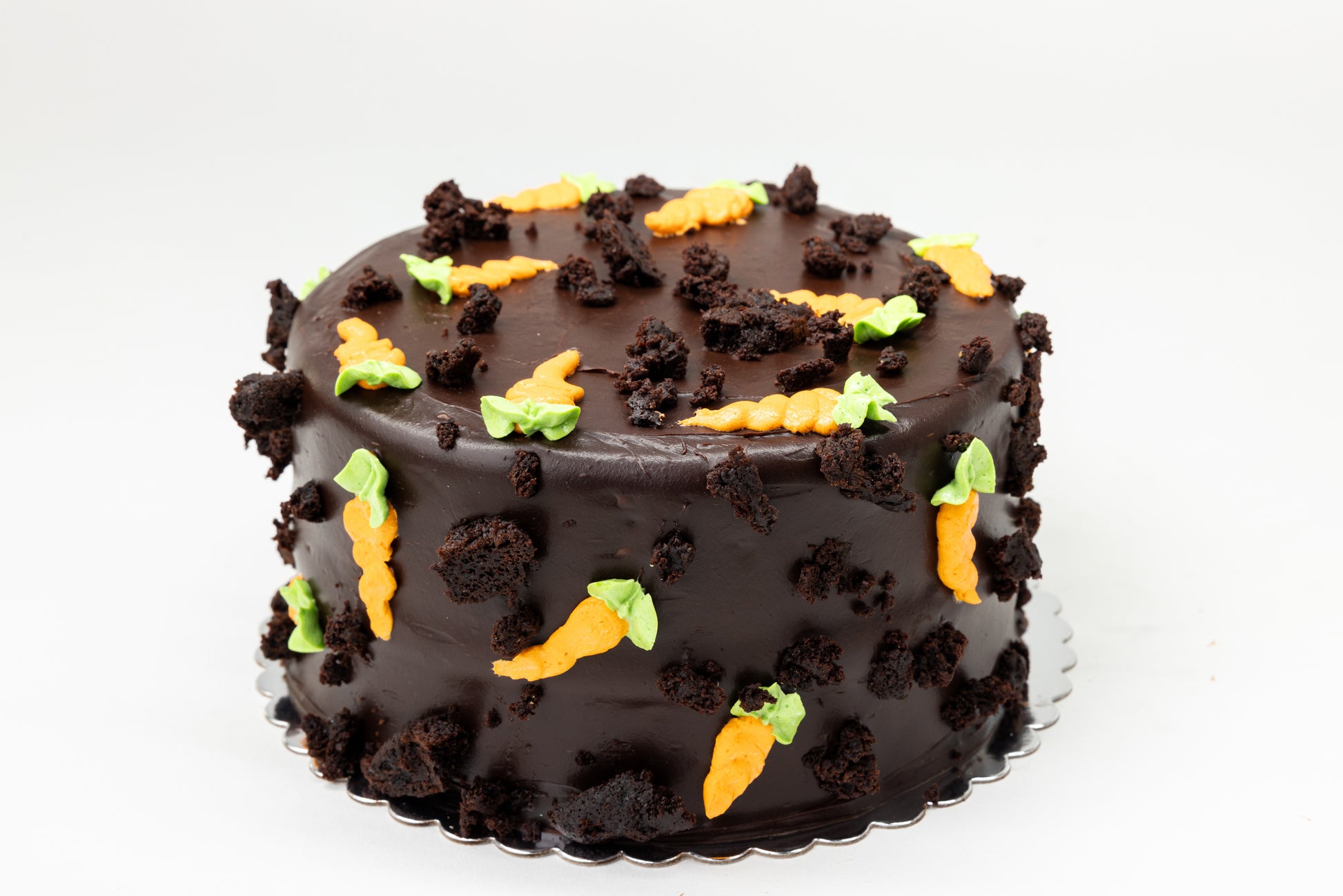 Chocolate cake with buttercream carrots on a white background