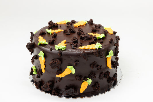 Chocolate cake with buttercream carrots on a white background
