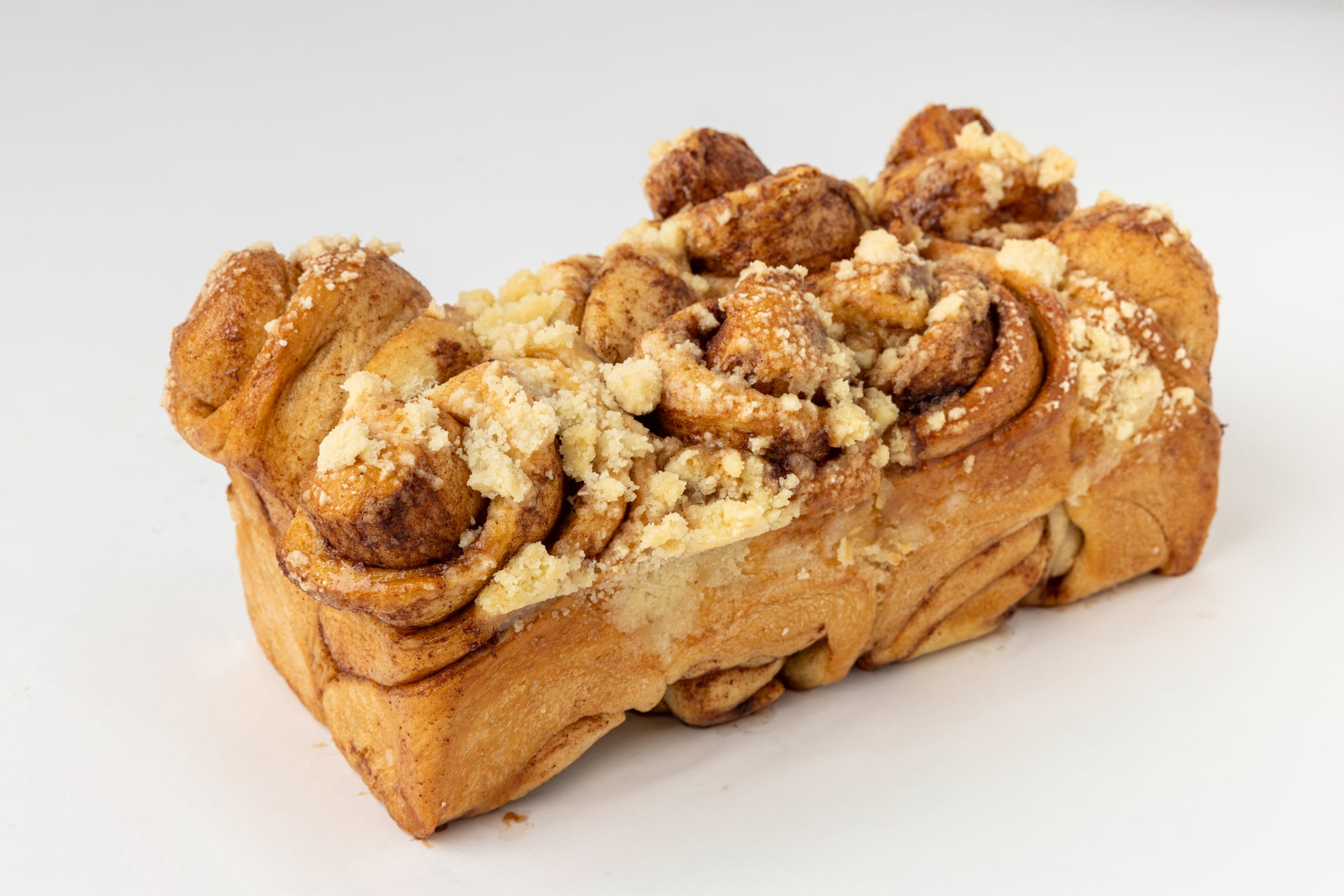 Braided bread with crumb topping on a white background