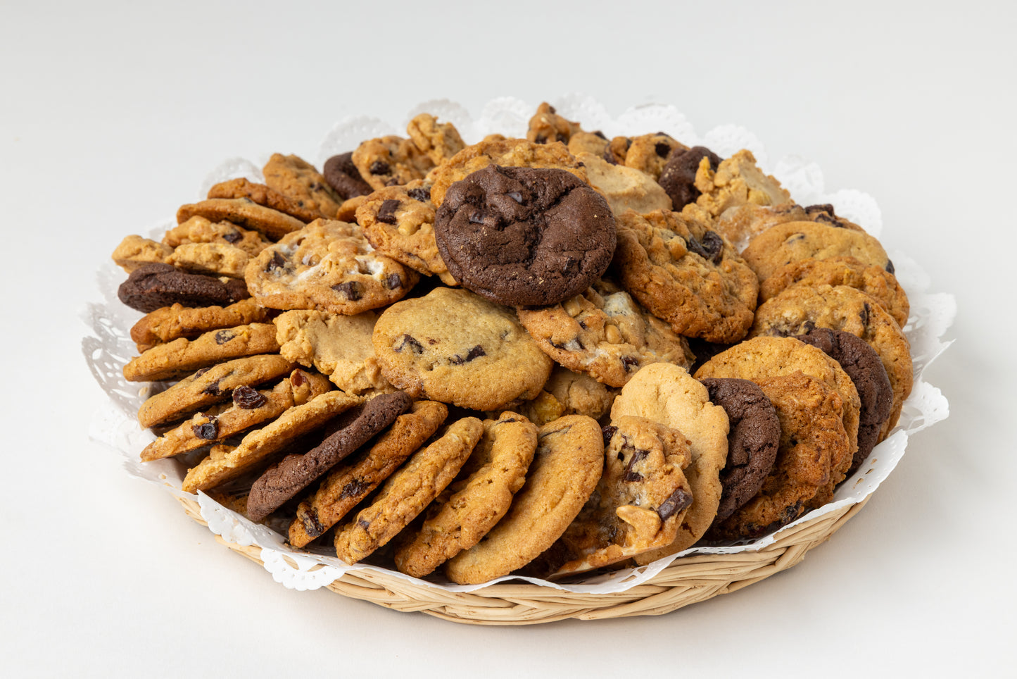 Assorted cookies in a basket on a white background