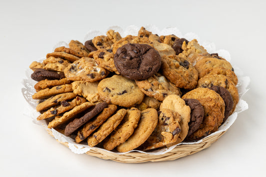 Assorted cookies in a basket on a white background
