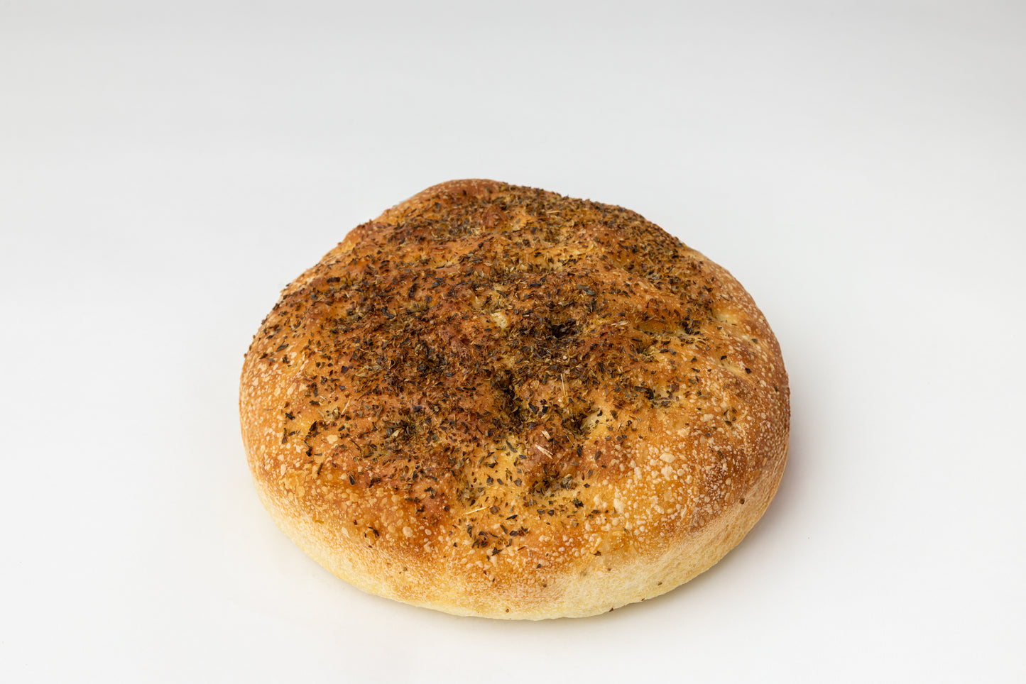 Focaccia loaf with oregano spice on a white background