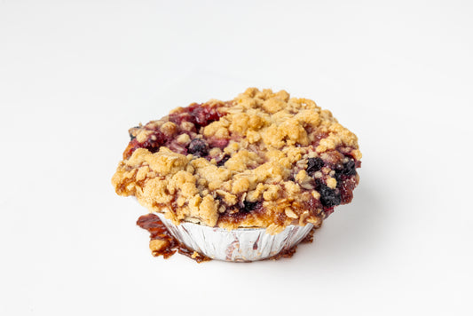 Crumble topped mini pie on a white background