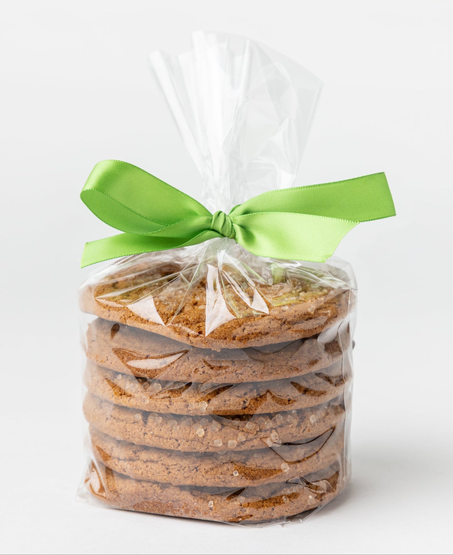Packaged cookies with a green ribbon on a white background