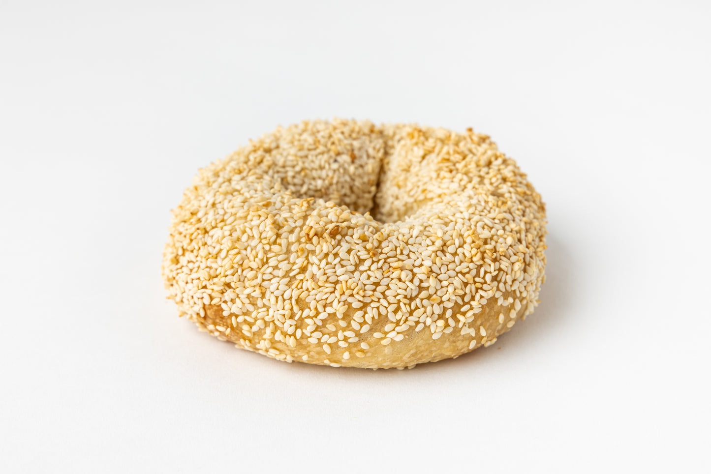 Sesame seed bagel on a white background