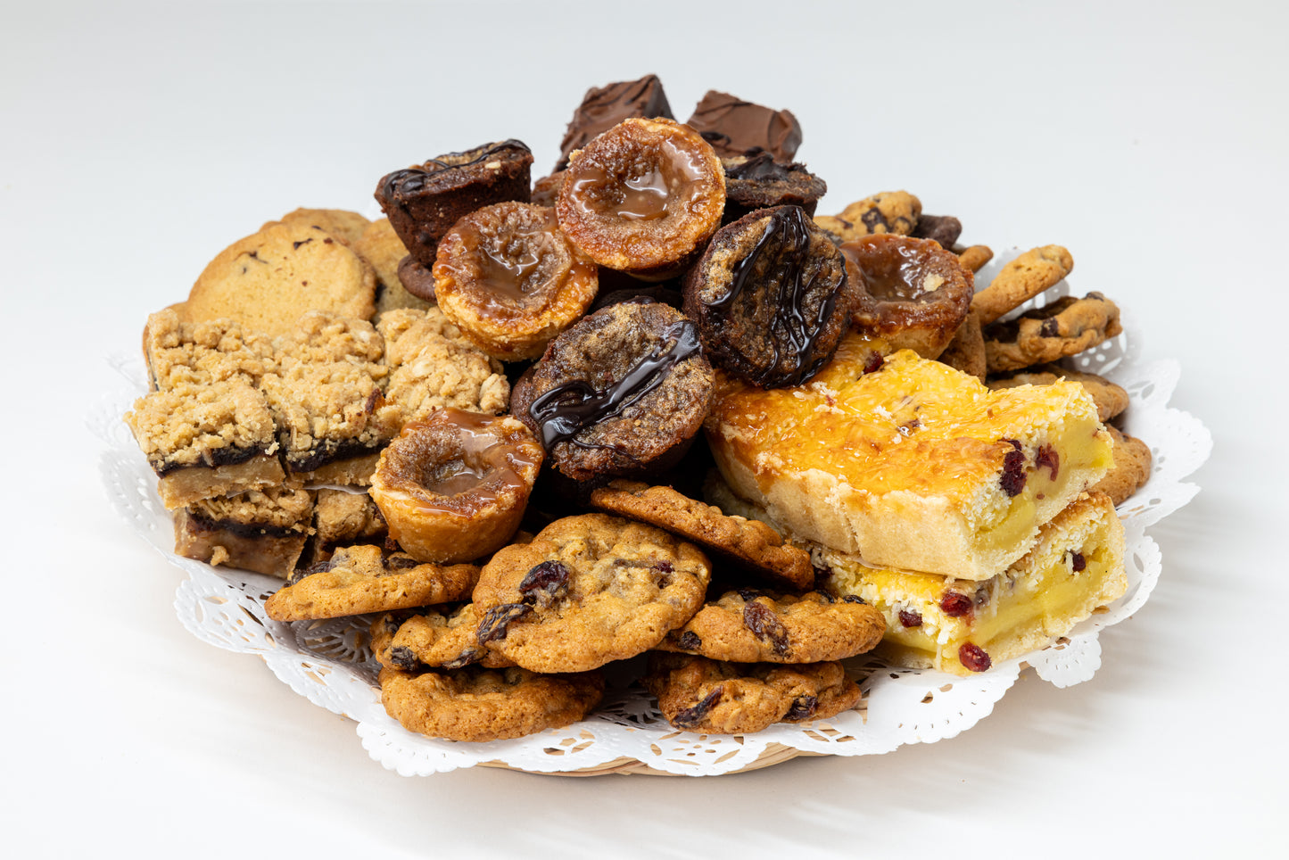 Assorted cookies, butter tarts and bars on a white background