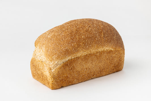 Beautiful, golden loaf of bread on a white background